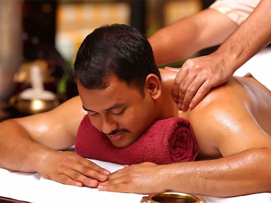 Man receiving a traditional Ayurvedic Abhyangam oil massage